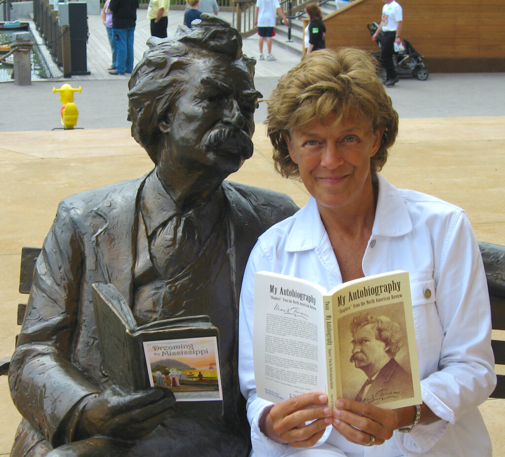 Professor Katherine Fischer of Clarke University in Dubuque Iowa with Mark Twain statue
